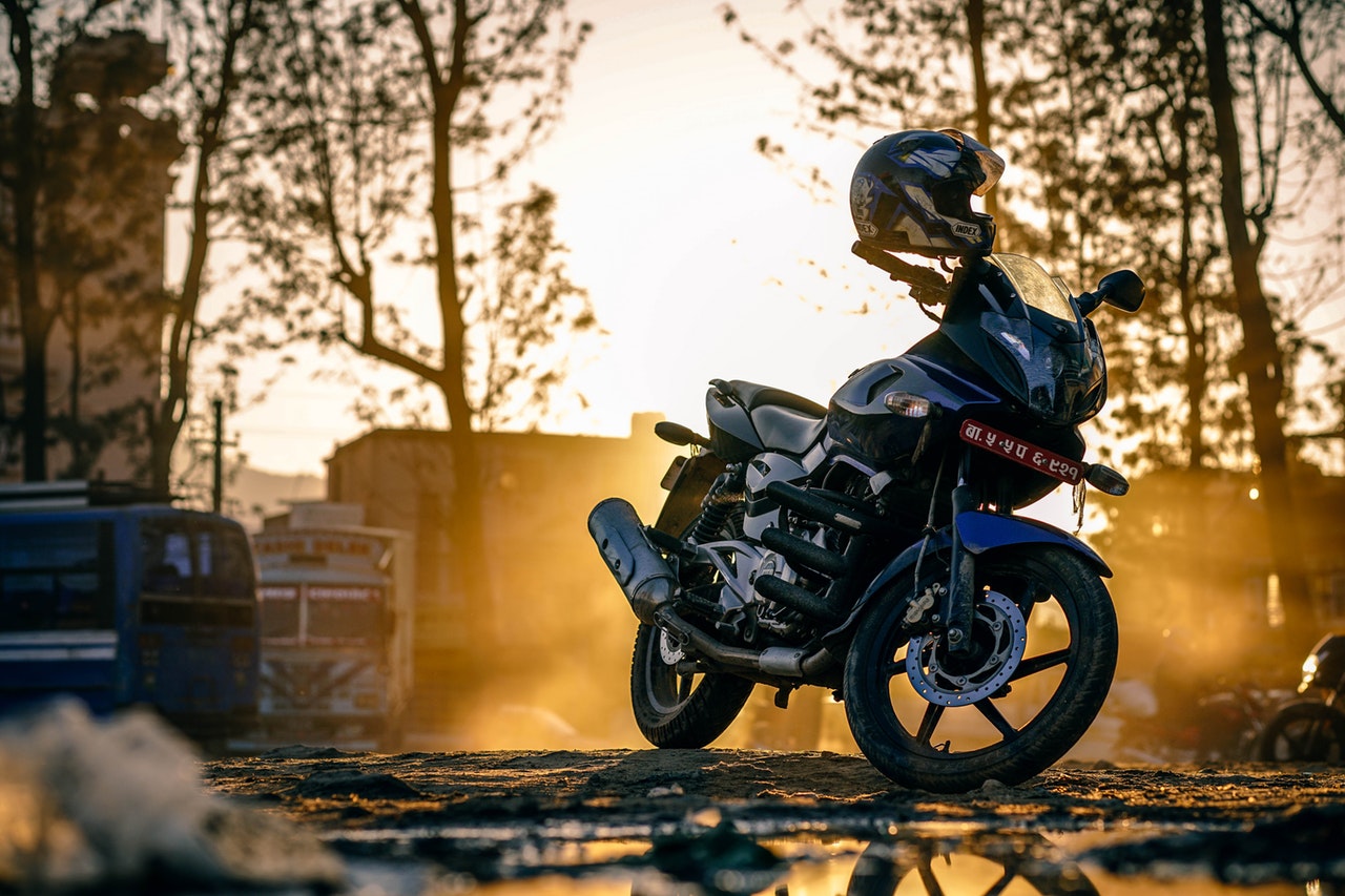a big black motorcycle with helmet on the rear view mirror